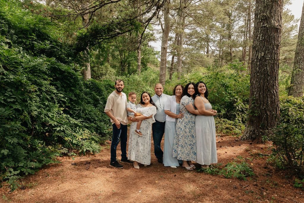 Family standing together on a wooded trail during a lifestyle session in North Georgia